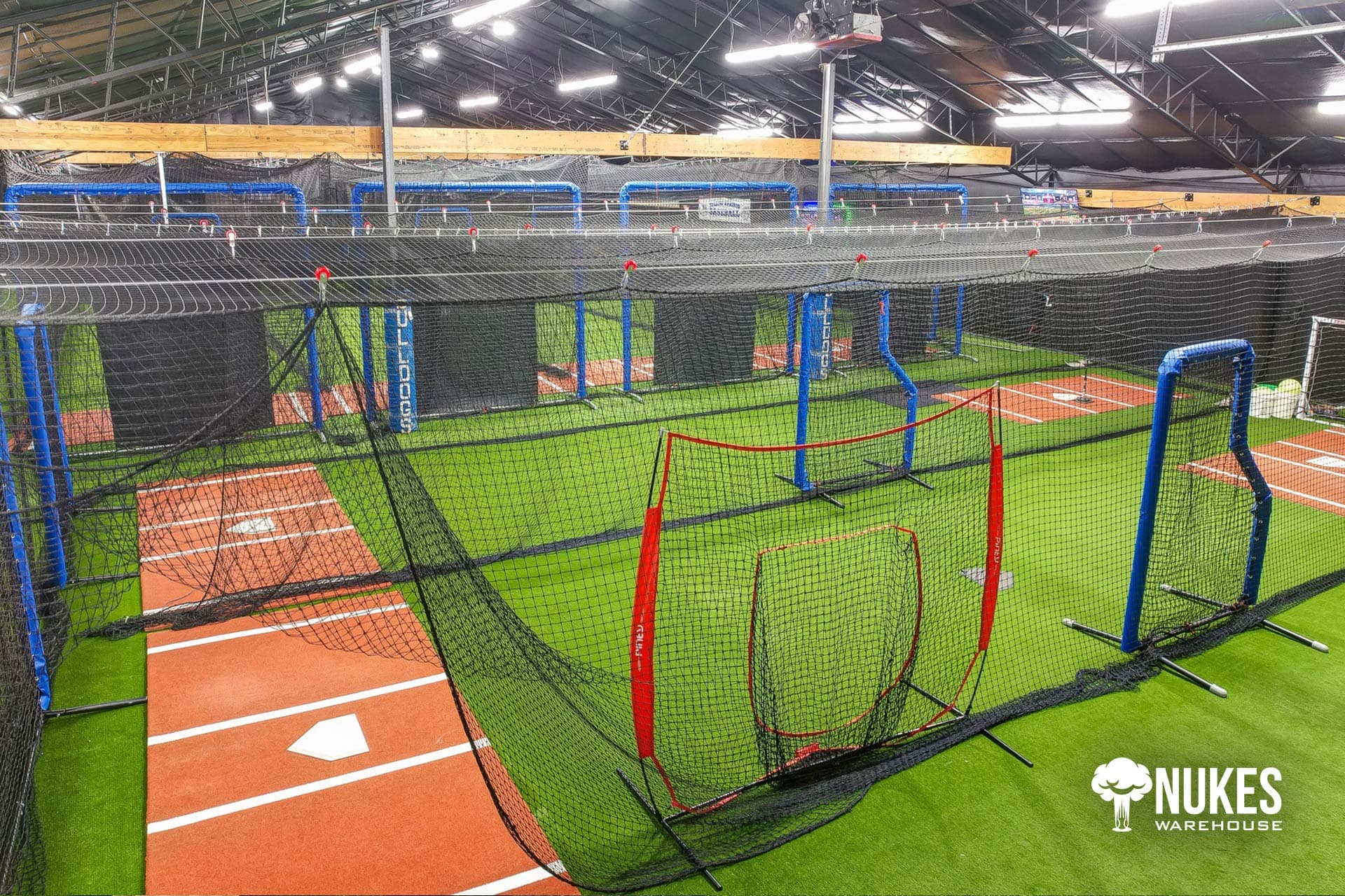 Training lanes with turf flooring and safety screens